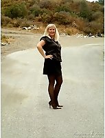 Black Seamless Pantyhose And High Heels In The Middle Of The Road