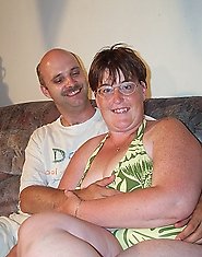 Mature couple having sex on their scruffy couch